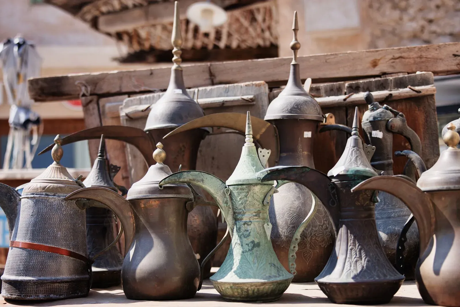Des cafetières anciennes en laiton exposées sur un marché