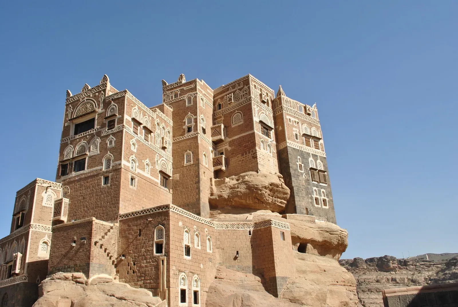 Le palais du Rocher, Dar al-Hajar, dressé sur son bloc de pierre dans les hauts plateaux yéménites